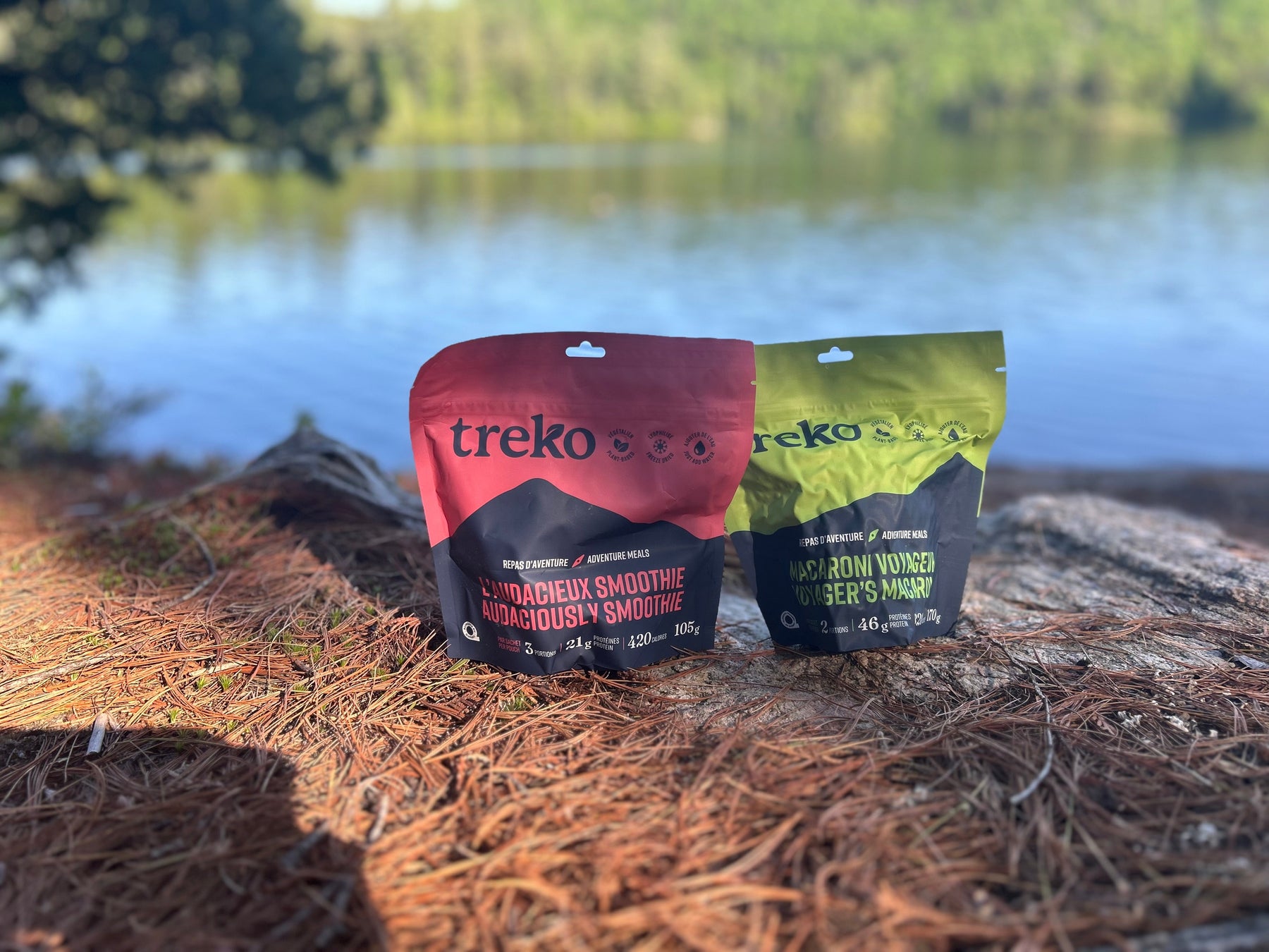 Treko freeze-dried meals (Smoothie and Macaroni) positioned on rock beside Canadian lake during 5-day hiking trip