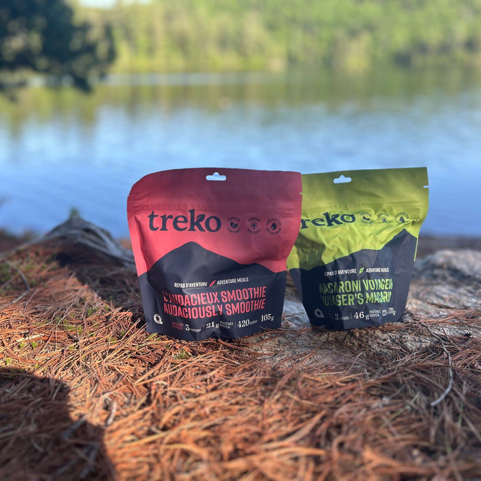 Treko freeze-dried meals (Smoothie and Macaroni) positioned on rock beside Canadian lake during 5-day hiking trip
